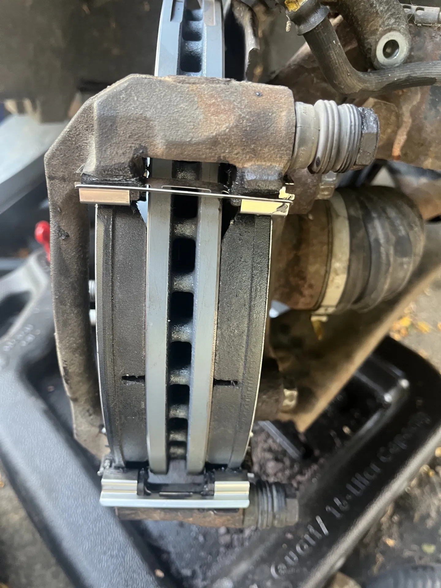Close view of brake pads, caliper and rotor during mobile service
