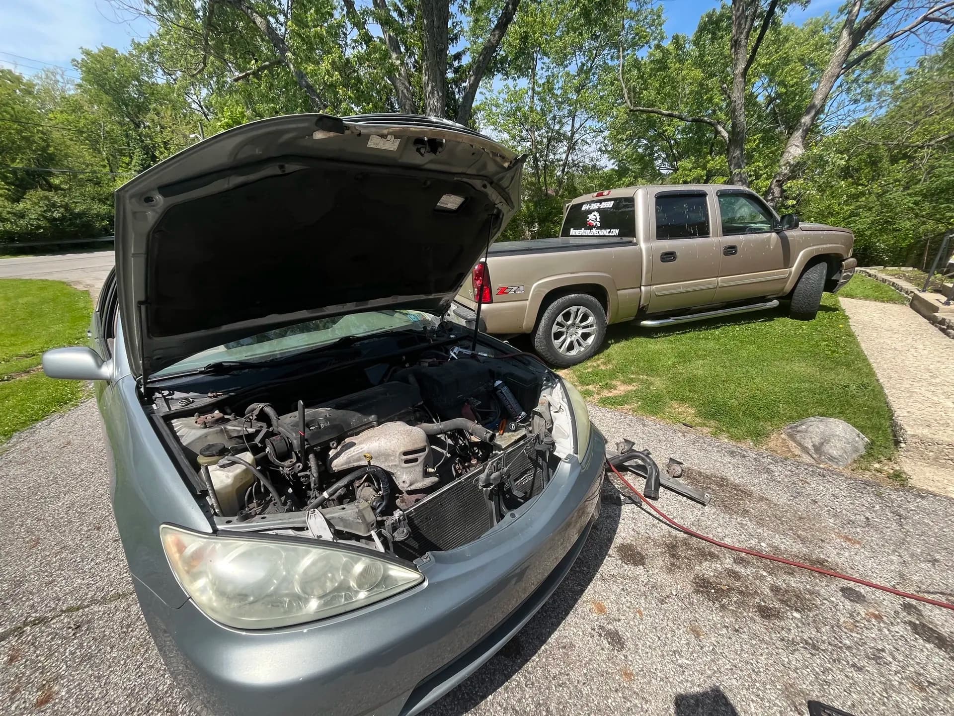 Vehicle receiving mobile maintenance in a Columbus-area driveway