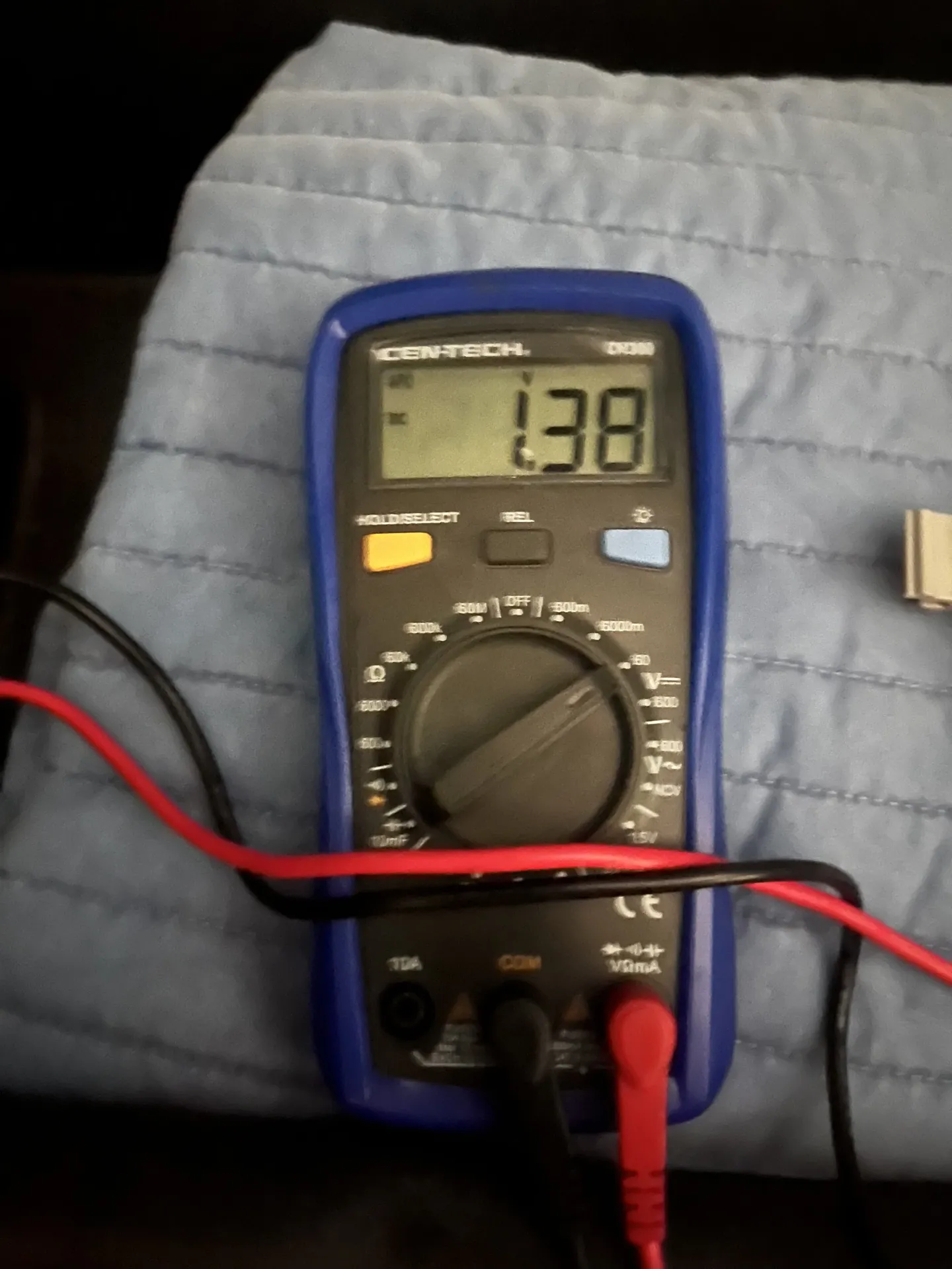 Digital multimeter used to test a vehicle battery during mobile electrical service