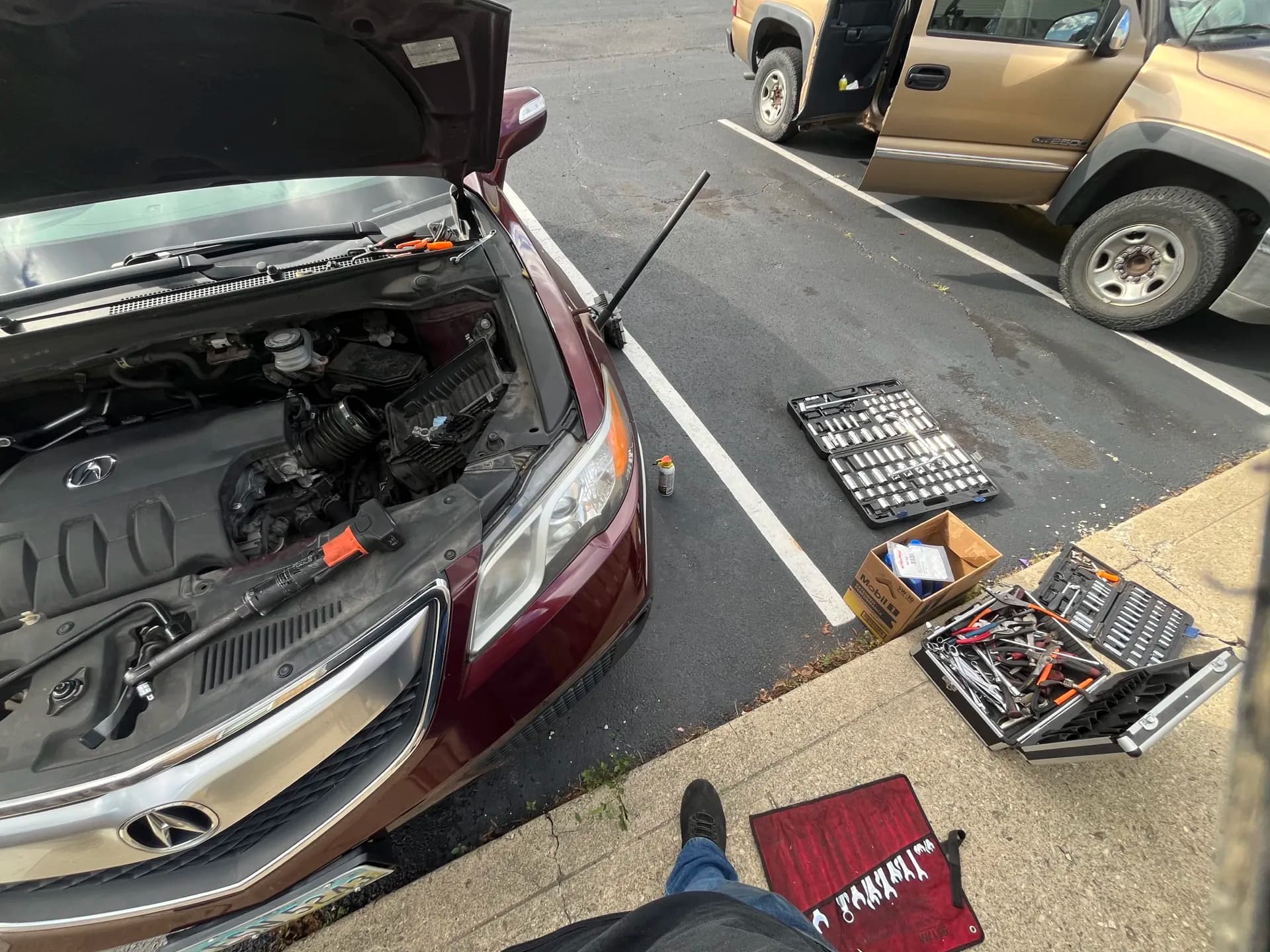 Professional tools laid out beside a vehicle during mobile engine diagnostics